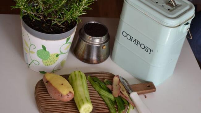 Compost container and food on cutting board